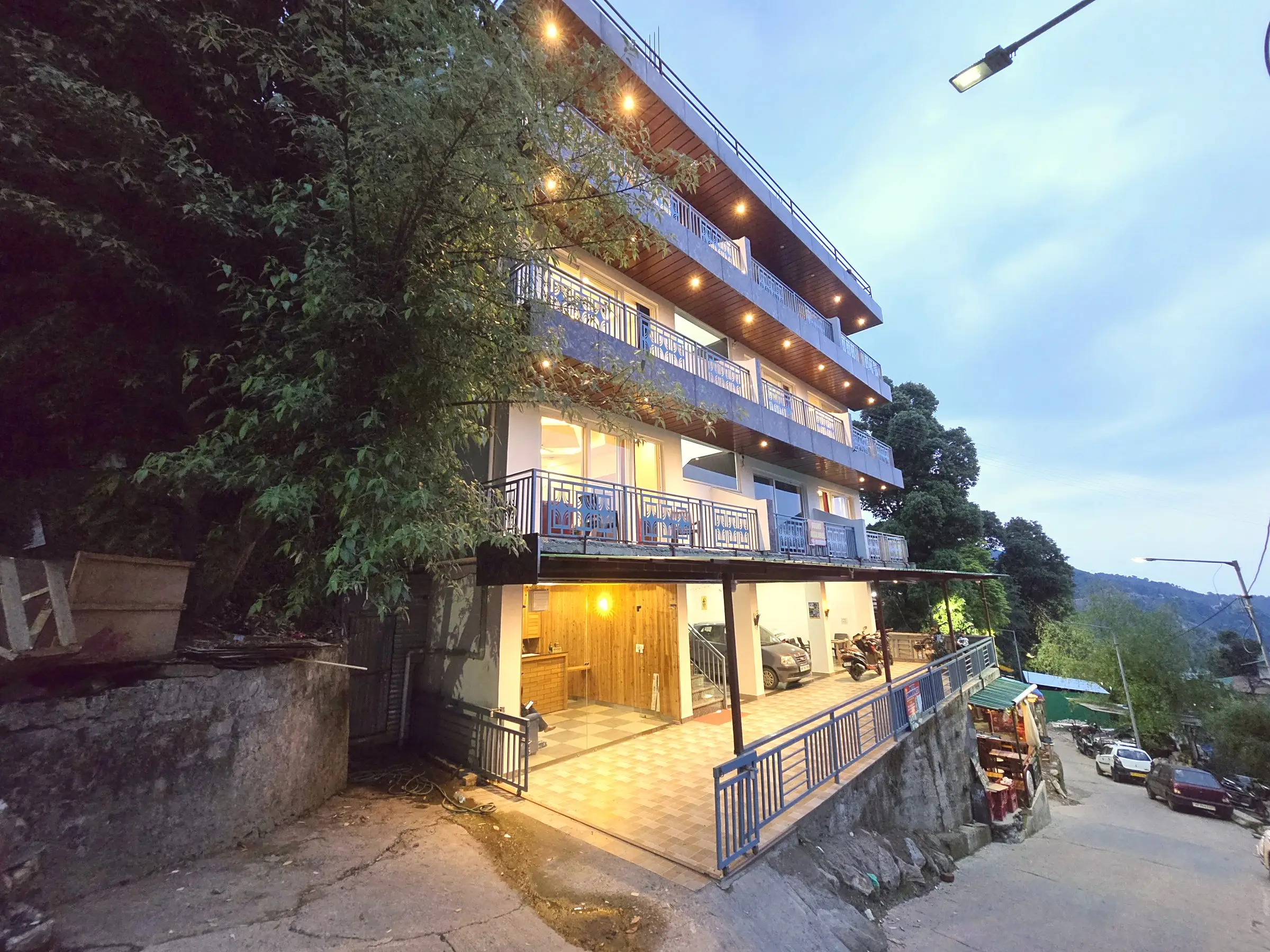 The building from the street at dusk, with balconies on each floor