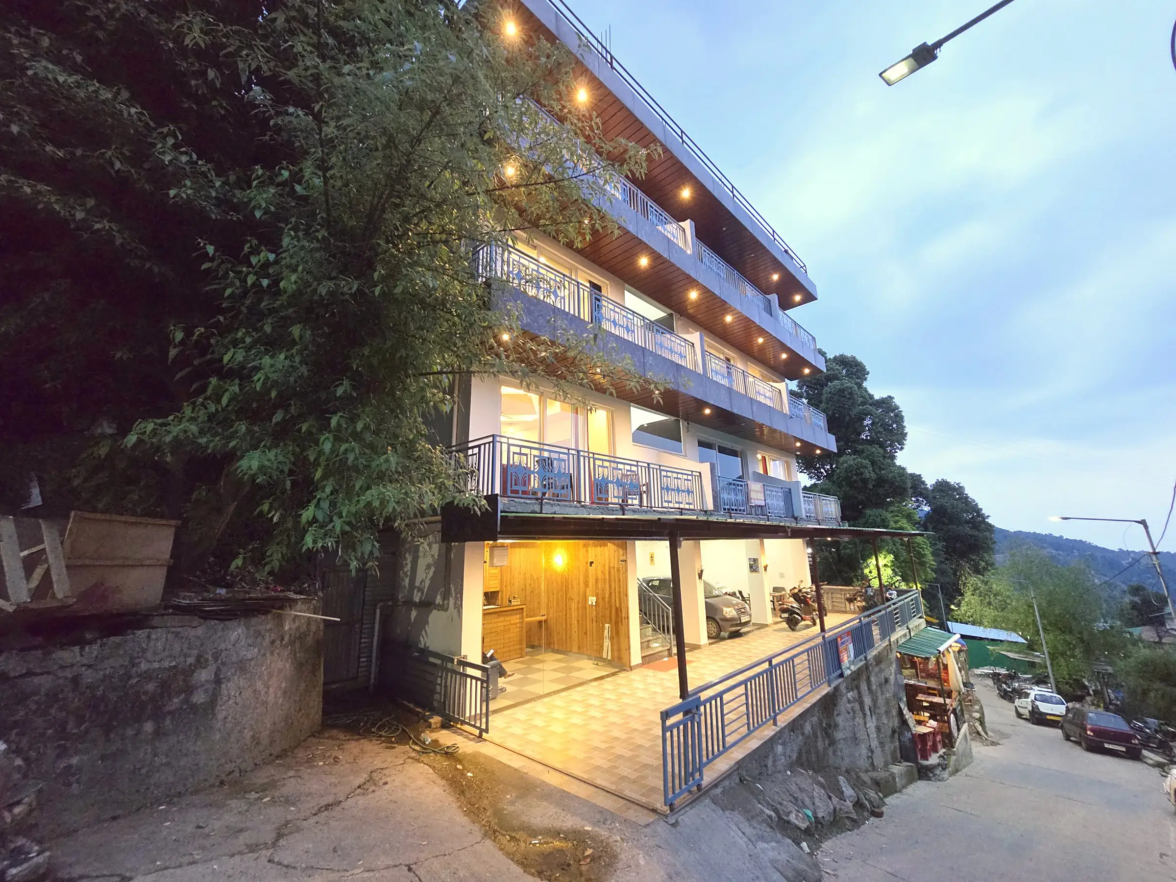 The building from the street at dusk, with balconies on each floor