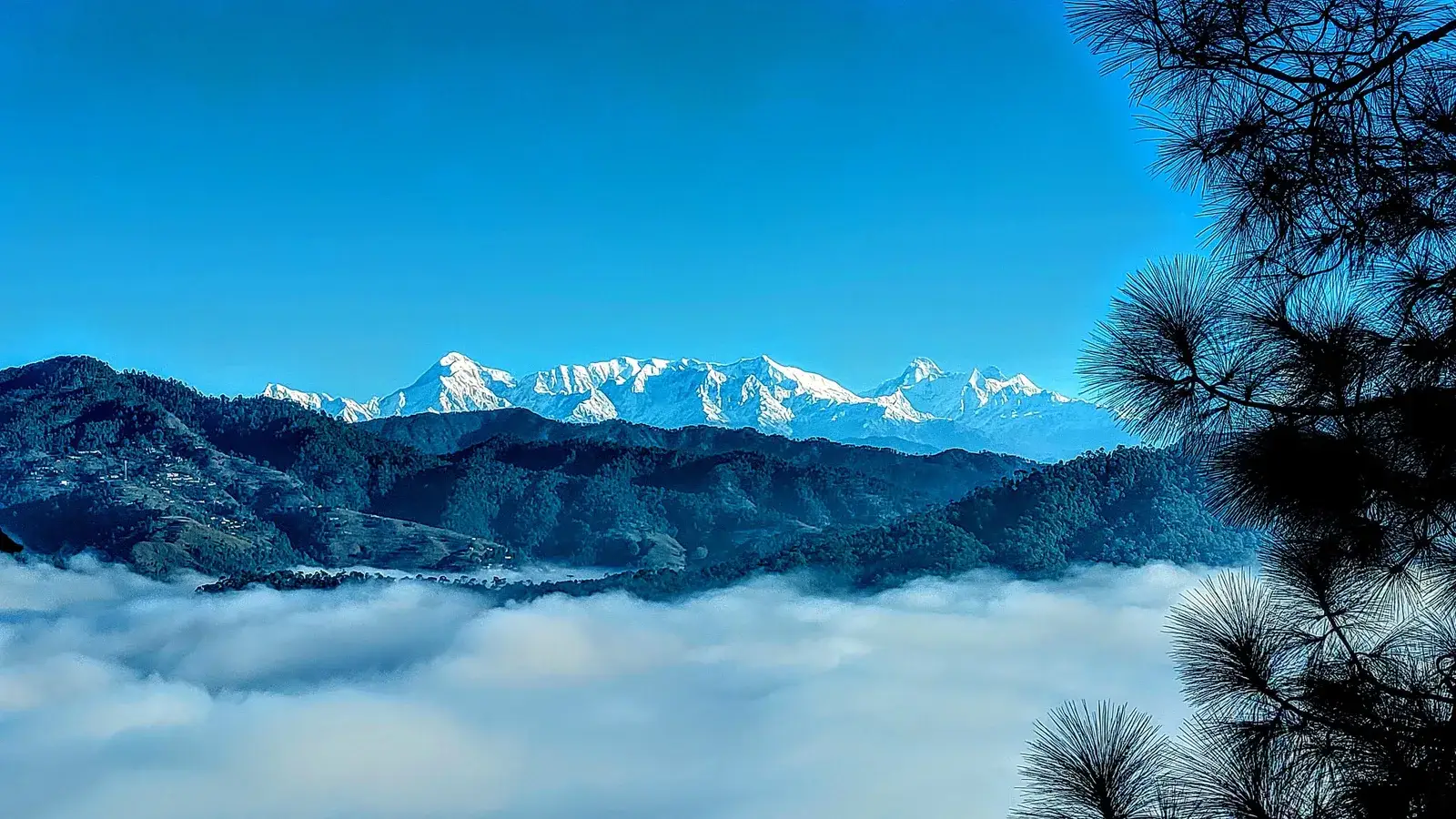 Snow peaks above a valley of cloud near Almora, Uttarakhand