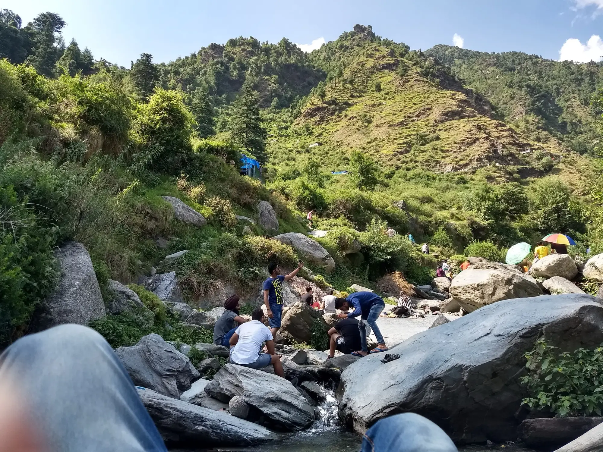 People on the boulders below the Bhagsu waterfall