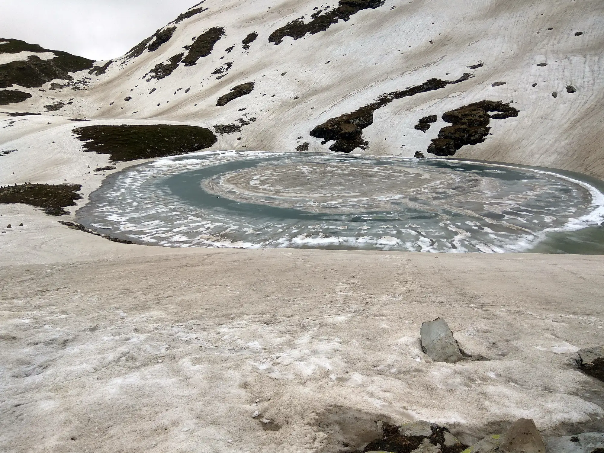 Bhrigu Lake, a small round lake still ringed with snow in June
