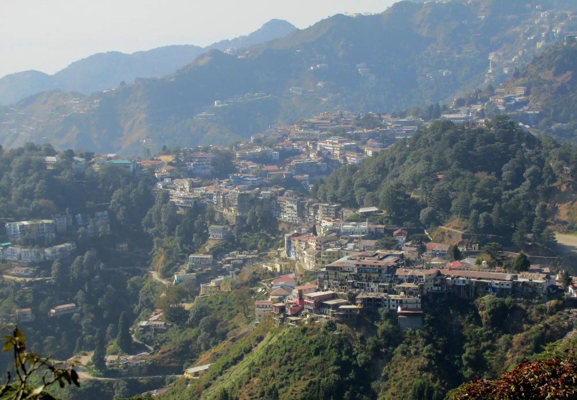 Mussoorie's houses stacked along a forested ridge