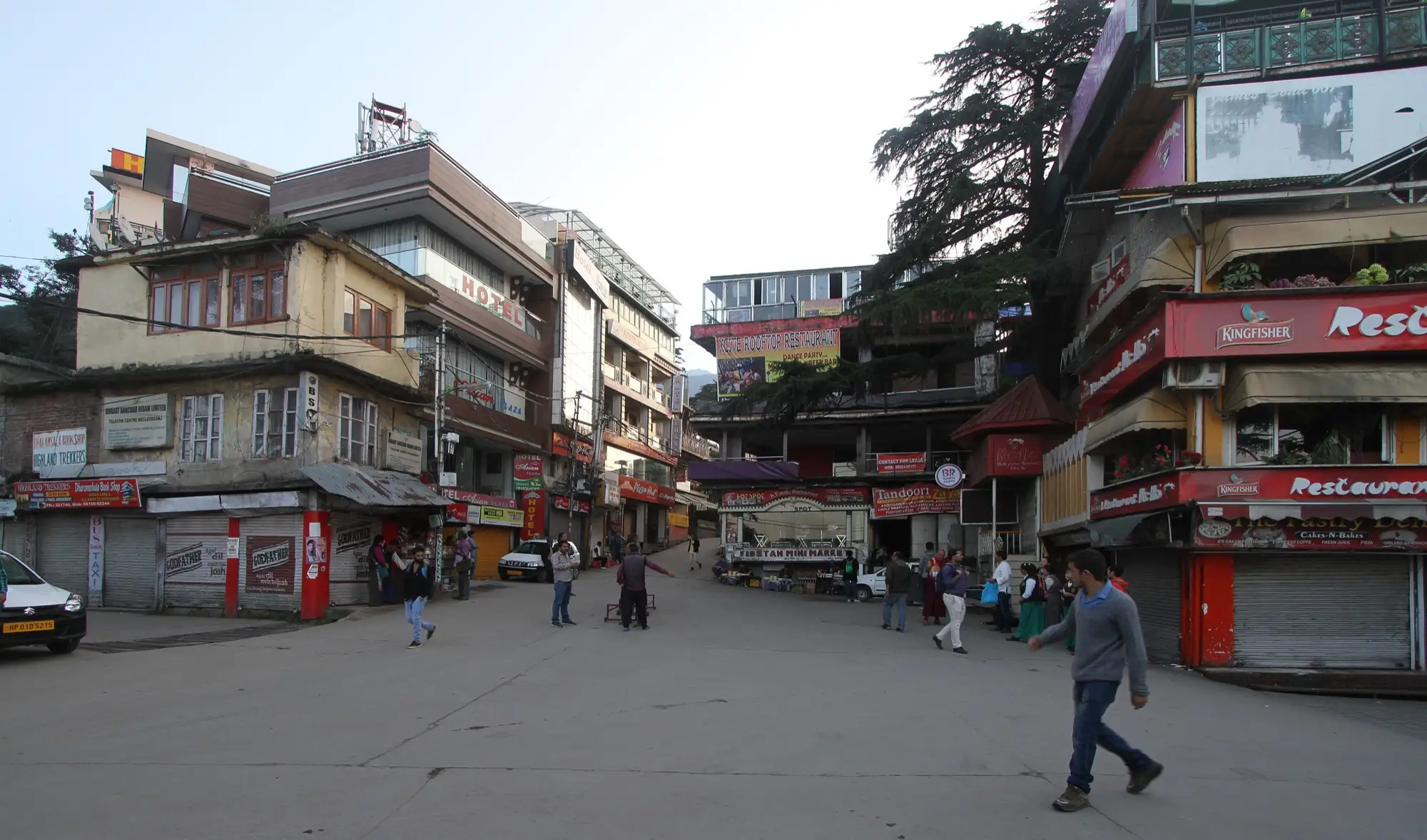 The main square in McLeod Ganj, with shops and signboards, early in the morning