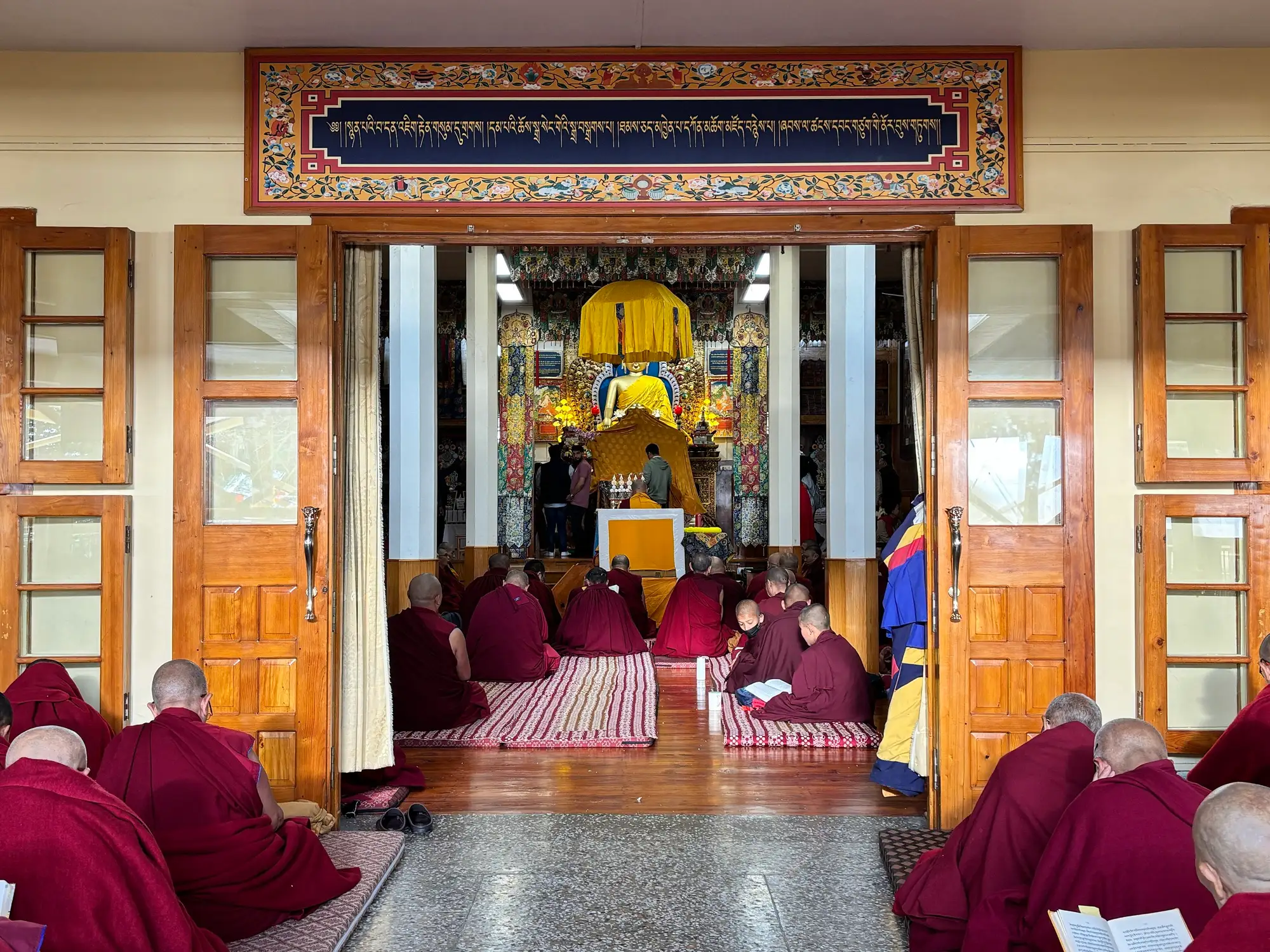 Monks seated in prayer inside Namgyal Monastery in McLeod Ganj