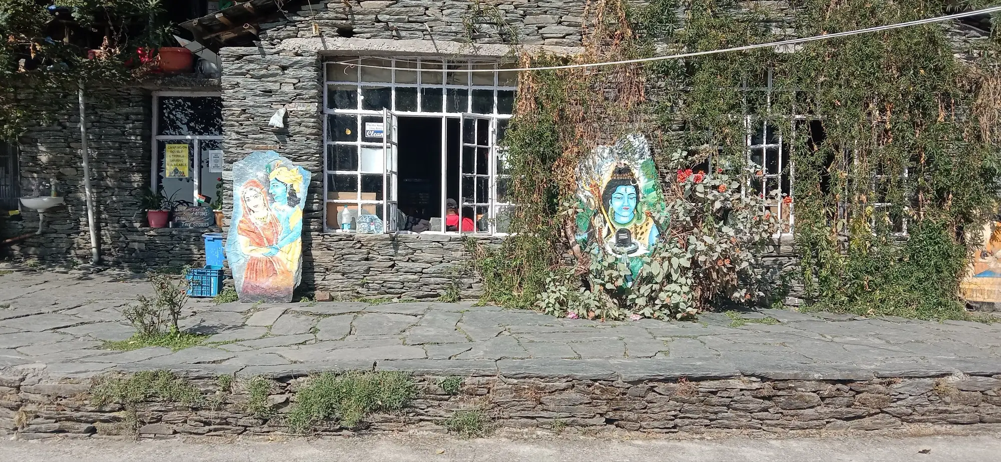 The painted stone front of Shiva Cafe above the Bhagsu waterfall
